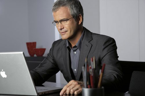 Мужчина в очках за ноутбуком